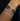 Stack of silver bracelets on a wrist against a dark background
