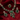 Jewelry set with emerald green stones on a red fabric background